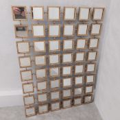 A contemporary gilt metal wall mirror of glazed sections connected by faux chain links. 102 x 75cm