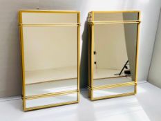 A pair of architecturally styled wall mirrors in gilt metal frames. 100 x 50cm