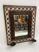 A continental style painted metal wall mirror fitted with twin candle sconces. 68x56cm.