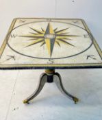 A tilt-top action dining table with a nautical compass style polychrome painted finish. 73 x 106 x