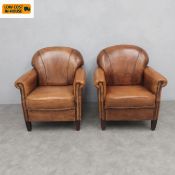 A pair of 20th century Dutch tan sheepskin leather club chairs. Seat height 39cm, back 91cm (Some
