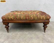 A large 19th century mahogany framed Ottoman or footstool with deep buttoned needlework