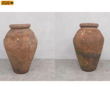 A pair of large early 20th century Italian terracotta olive jars with glazed interiors by Carlo