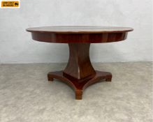 A 19th century mahogany extending dining or centre table with circular top over a faceted stem