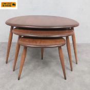 A vintage nest of three beech and elm Ercol Pebble tables with maker's labels. H.40 W.66cm largest