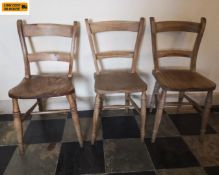 A set of three C.1900 elm seated Oxford bar back Windsor dining chairs. H.83cm.