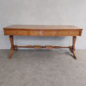A 19th century North European satinwood Biedermeier side table fitted with three frieze drawers on