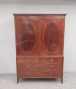 A late 19th century Regency style mahogany and satinwood inlaid linen press with upper section