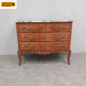 An early 20th century walnut commode or chest of drawers in the Louis XV style having a serpentine
