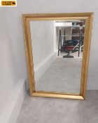 A contemporary wall mirror with bevelled plate in a simple gilt frame. H.86.5 W.61cm