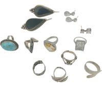 A collection of silver jewellery to include two pairs of pierced earrings and eight silver rings,