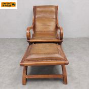A 20th century teak framed and tan leather upholstered colonial plantation style armchair and