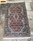 A vintage Kashan style rug with central lozenge medallion surrounded by allover repeating flowerhead