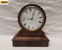 A small Regency mahogany mantel clock with brass mounted dial. H.17cm