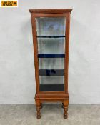 An early 20th century oak vitrine or display cabinet with dentil moulded cornice over a glazed trunk