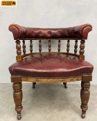 A Victorian oak framed and oxblood leather upholstered library or desk armchair of tub form raised