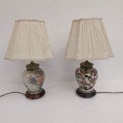 Two hand painted and gilt Japanese Kutani style ceramic table lamps with shades on wooden bases. H.