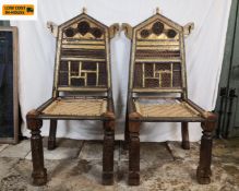 A pair of 19th century Indian hardwood Pida chairs each with a hammered brass mounted back over a