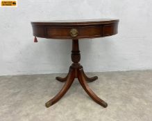 A Georgian style mahogany drum table with circular leather inset top over brass mounted frieze