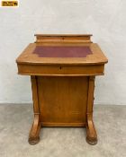 A late 19th century walnut davenport desk with marquetry inlaid and red leather lined slope