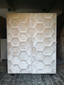 A contemporary floor standing cabinet with velvet upholstered panel doors. H.159 W.121 D.49cm.
