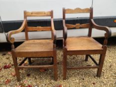 A near pair of 19th century oak armchairs with panel seats on square tapering supports. H.91cm.