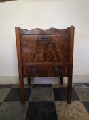 A Georgian mahogany night or bedside cabinet with pierced galleried back above drawers and doors.