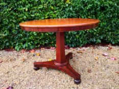 A mid 19th century mahogany tilt top dining table on triform pedestal base. H.74 Dia.100cm.