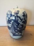A late 19th century Qing blue and white lidded jar with bird of paradise and blossom decoration. H.