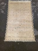 A hand knotted Eastern wool carpet, label to reverse. 200x120cm.