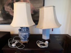 A vintage Chinese blue and white table lamp with shade along with a Blanc de Chine example. H.