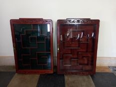 Two Chinese carved and lacquered teak wall hanging display cabinets fitted with shelves. H.67 W.46