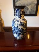 A 19th century Chinese blue and white baluster form vase, hand decorated and signed to base with wax