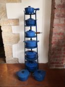 A collection of eight Le Creuset lidded pans with a six tier stand. Dia.27cm. (Largest).