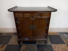 A Korean elm side cabinet with drawers above panel doors fitted with brass butterfly locks and