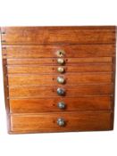 A 19th century mahogany table top specimen chest with locking hinged lid compartment above six