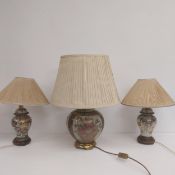 A pair of vintage Japanese satsuma vase table lamps with shades along with a similar larger example.