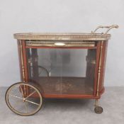 A mid 20th century Italian marquetry inlaid bar cart with brass openwork gallery surround over a