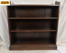 A 20th century mahogany open bookcase with four shelves raised on a square plinth base. H.96 W.92