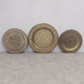 Three Middle Eastern or North African brass repousse wall hanging and tabletop trays. Dia.73cm (