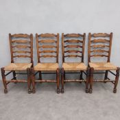 A set of four 19th century elm Lancashire ladder back dining chairs with rush seats on turned