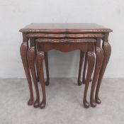 A 19th century style mahogany nest of three graduating occasional tables each having a quarter-