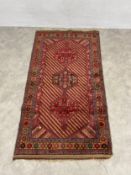 An Afghan Mushwani village rug with central pole medallion over a striped ground within repeating