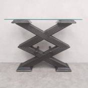 A vintage console table with plate glass top raised on an angular ebonised faux bamboo and rattan