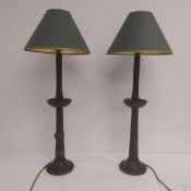 A pair of early 20th century turned mahogany table lamps with copper collars and green shades. H.