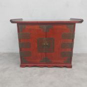 A vintage Chinese jewellery or specimen cabinet with an everted top over a pair of brass mounted
