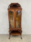 A late 19th century Art Nouveau style oak display cabinet or vitrine in the manner of Emile Galle,