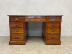 A late 19th century walnut three section pedestal desk with inset leather writing surface by