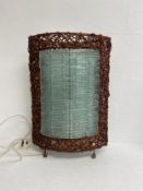 A contemporary wicker bound metal framed table lamp with light shades made of individual glass