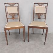 A pair of C.1900 rosewood side or hall chairs each having a marquetry inlaid and openwork splat over